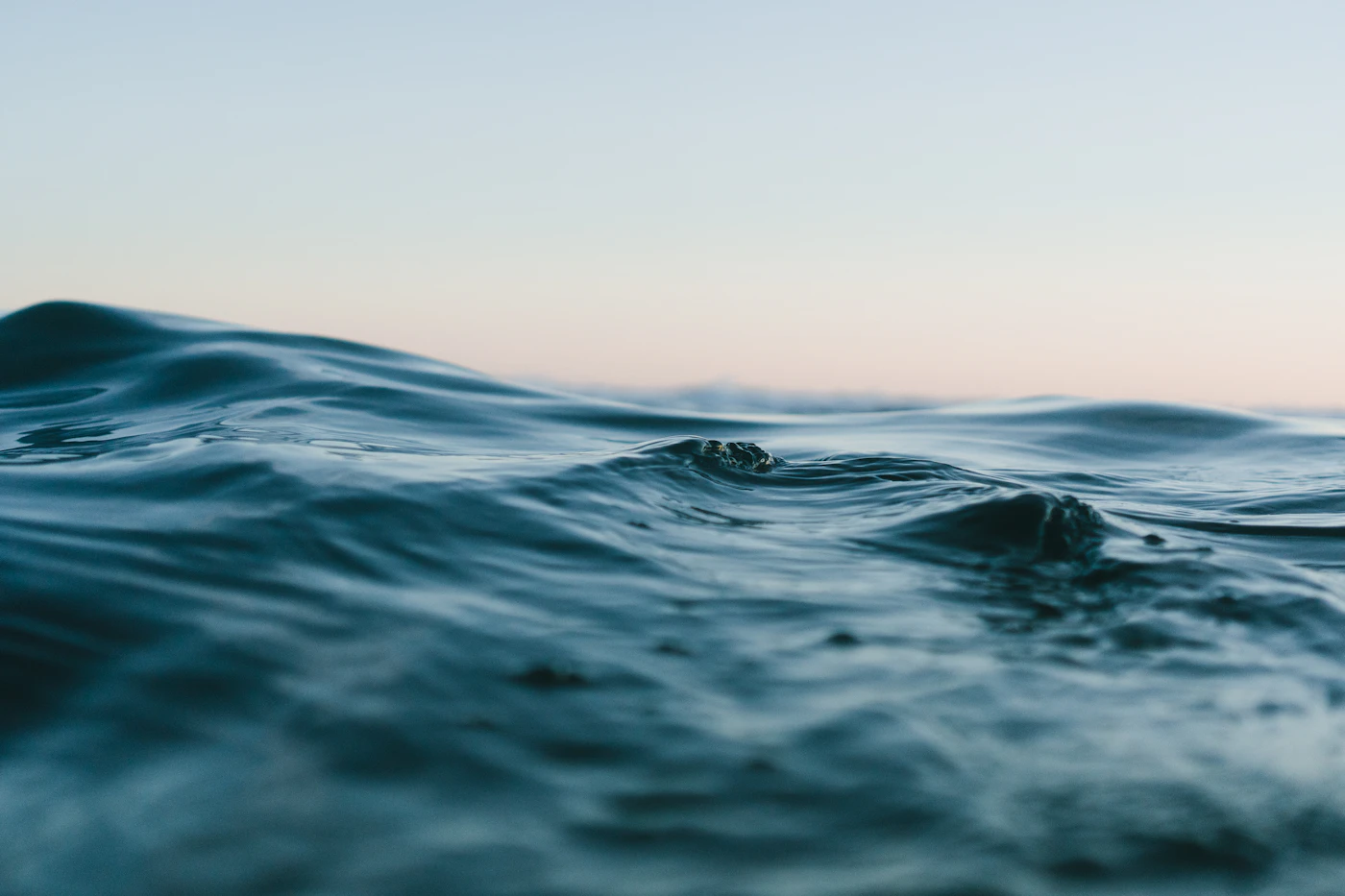 Ocean waves under a softly lit sky